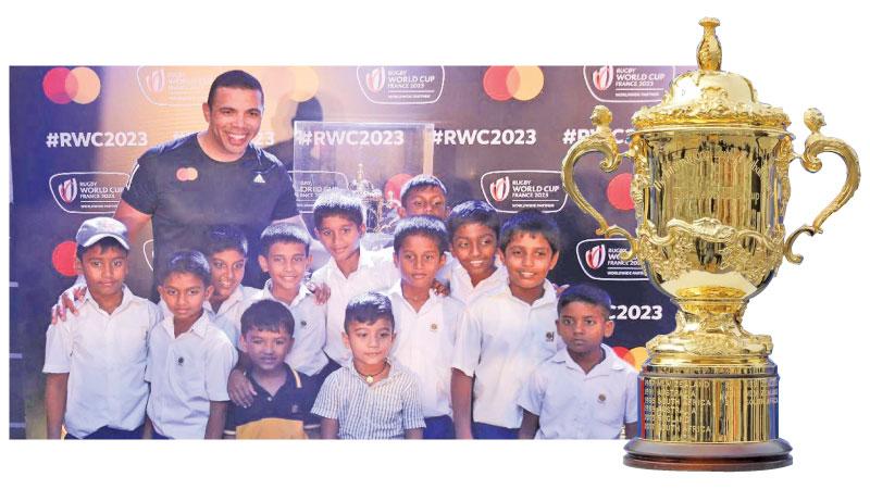 School children pose in front of the World Cup with former South African winger Bryan Habana (Pic: kapilasudat@mediafactory)-The William Webb Ellis trophy