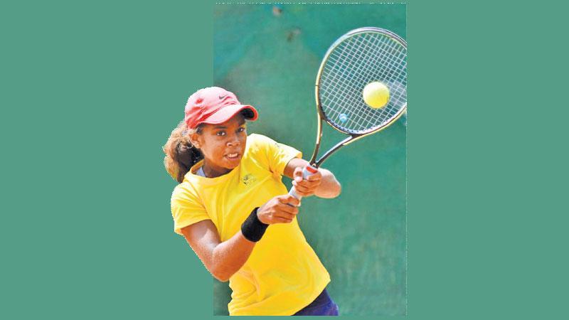 Sri Lanka’ number one Dinara de Silva plays a return back hand stroke