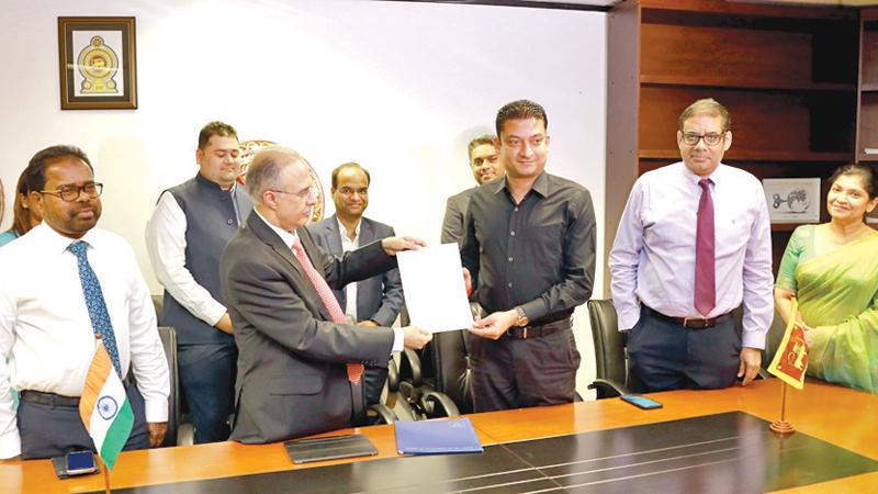 Managing Director, Adani Energy, Anil Sardana, State Minister of Investment Promotion, Dilum Amunugama, Secretary, Ministry of investment Promotion, M. M. Naimuddin, Chairman, BOI, Dinesh Weerakkody and Director-General, BOI, Renuka Weerakone at the signing ceremony.