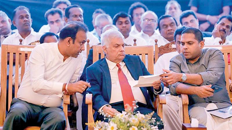 President Ranil Wickremesinghe flanked by Tourism and Lands Minister Harin Fernando and Minister of Plantation Industries, Dr. Romesh Pathirana.