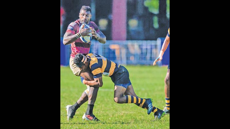 Havelocks Number Eight Nivanka Prasad is tackled by an Army SC defender