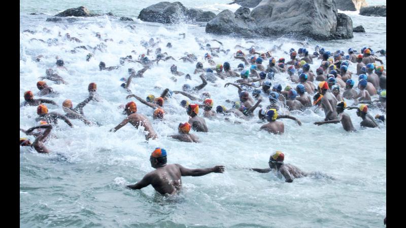 Swimmers hit the water at Mount Lavinia at the start of the race