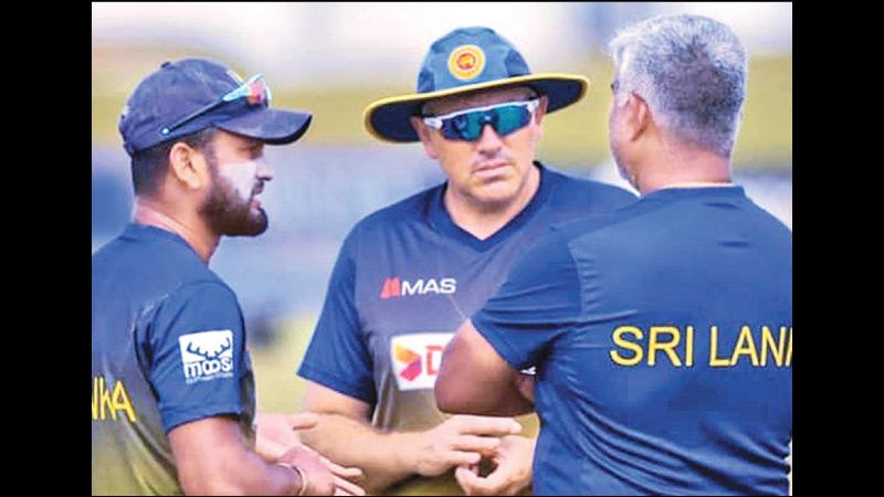 Sri Lanka cricket head coach Chris Silverwood, skipper Dimuth Karunaratne and chairman of the Selection Committee Promodya Wickramasinghe discussing  during a training session.