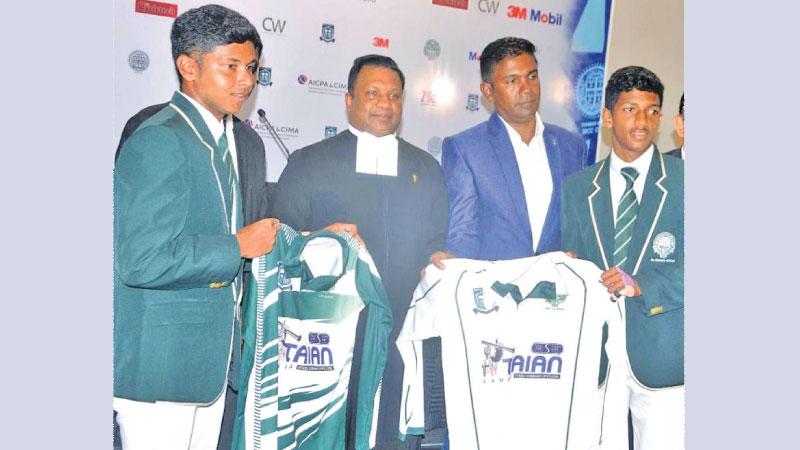St. Benedict’s College captain Chamath Chathurya (left) and his deputy Sharujan Shammuganathan display their playing kits in the presence of their College director Rev Bro Pubudu Rajapakse (Pix by Sudath Malaweera)