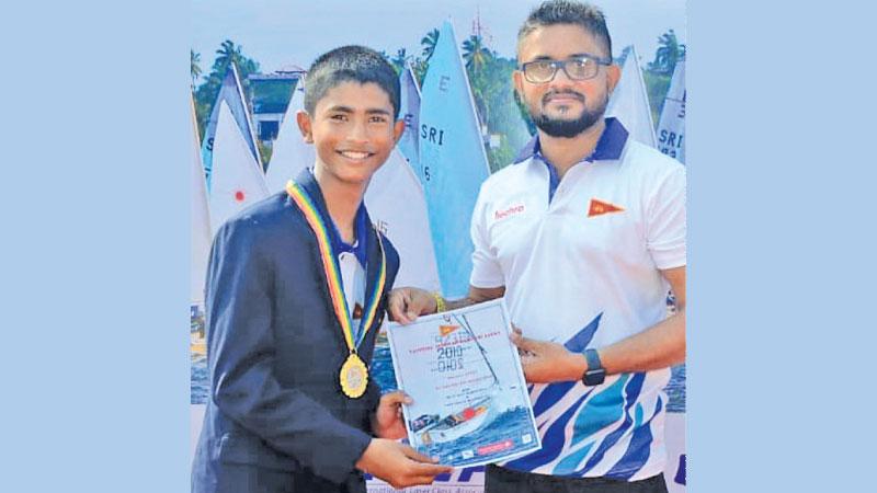 Yusef Hazari (left) Gold medal winner accepts his certificate from Captain Dumindu Abeywickrama, the vice president of the Yachting Association of Sri Lanka and chairman of Sri Lanka Navy Sailing