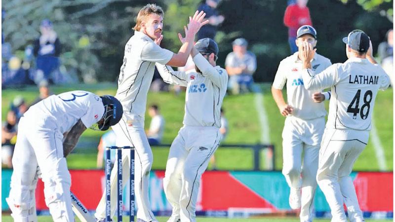 New Zealand bowler Blair Tickner takes the wicket of Kusal Mendis and celebrates with Kane Williamson on the third day of the first cricket Test against Sri Lanka in Christchurch yesterday