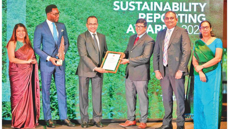 Commercial Bank’s Chief Operating Officer S. Prabagar (third from left) receives the ACCA award. The Bank’s DGM, Retail Banking and Marketing Hasrath Munasinghe (second from right) and Senior Manager, Sustainability, Women’s Banking and CSR Mrs Kamalini Ellawala (extreme right) look on.