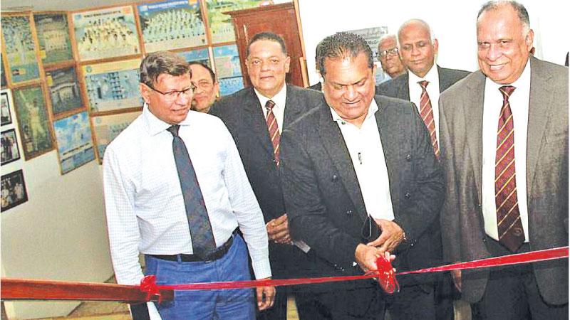 NCC president Marlon Ranasinghe (right) looks on as Sri Lanka Cricket (SLC) president Shammi Silva cuts the ribbon to commission a new-look clubhouse in the presence of SLC secretary Mohan de Silva (left) and the club’s secretary Peter Jayasinghe (Pic by Dushmantha Mayadunne)
