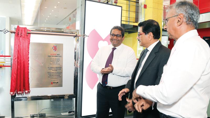From left: Director/CEO of Seylan Bank, Kapila Ariyaratne,  Governor of Central Bank of Sri Lanka Dr. Nandalal Weerasinghe and Chairman of Seylan Bank Ravi Dias unveil the plaque to commemorate the 35th anniversary.