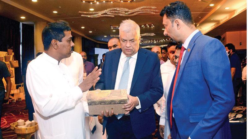 President Ranil Wickremesinghe participated in a  ceremony at the BMICH to appreciate craftsmen. Here the President inspects one of the products.  Pic: Wasitha Patabendige