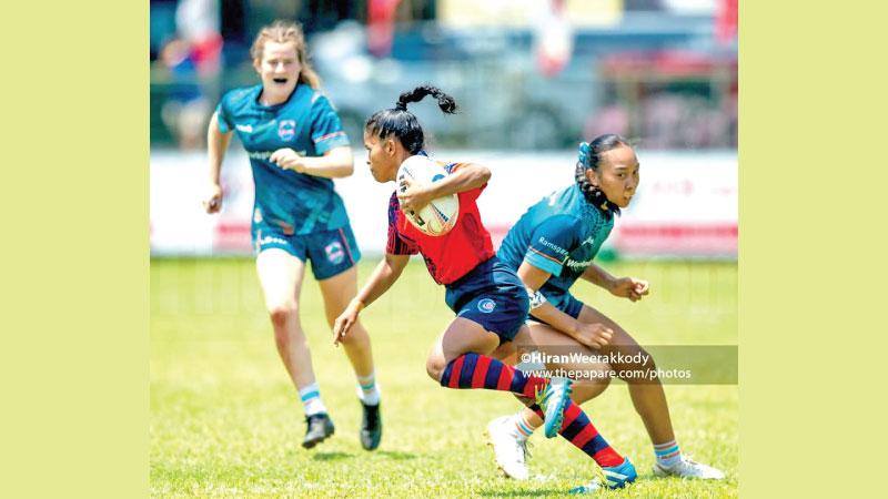 Hashini Samarawickrema side steps a tackle against the Burraneer Women’s Rugby Club of Australia during the CR and FC Centenary Rugby Sevens last week at Longden Place in Colombo (Pix thePapare.com)