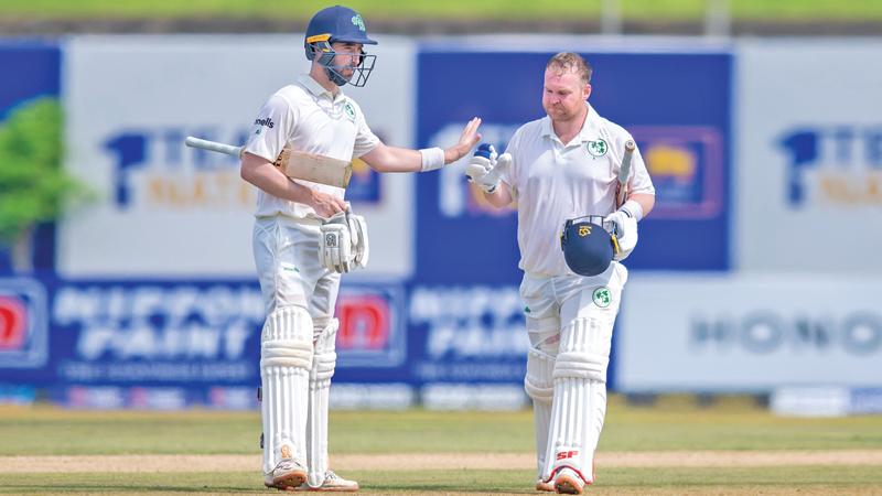 Skipper Andy Balbirnie (left) congratulating Paul Stirling during their third wicket partnership at the opening day of the second Test yesterday. (Pix courtesy SLC)