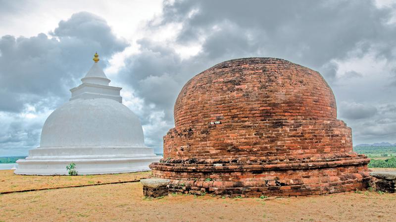 The newly renovated dagaba and the age-old reddish brick dagaba on the Bandagiriya rock boulder