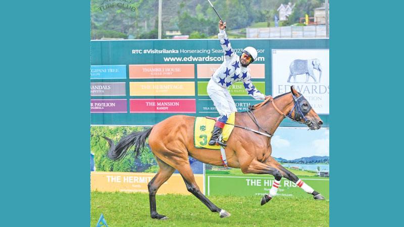 Jockey L. Ravi Kumar reacts after racing his horse named Here and Now to victory