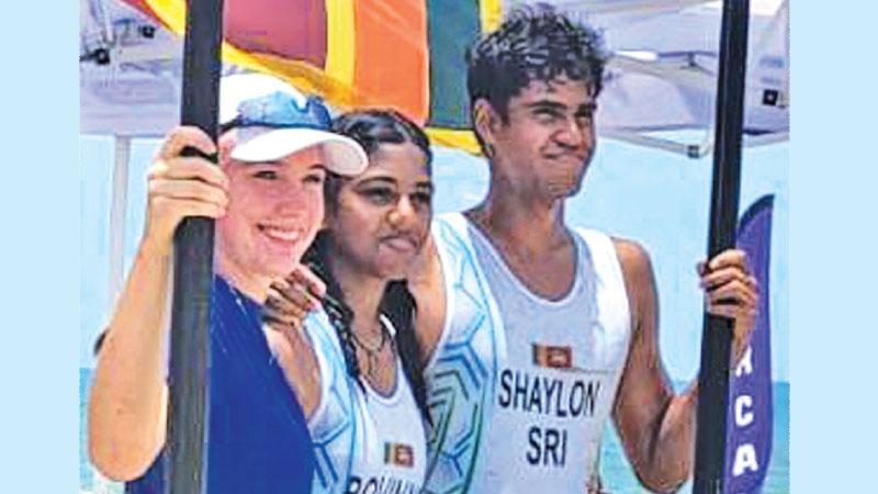 Sri Lanka’s medal winners Shaylon Gunaratne (right) and Rovinya Wijesekera (entre) in Thailand