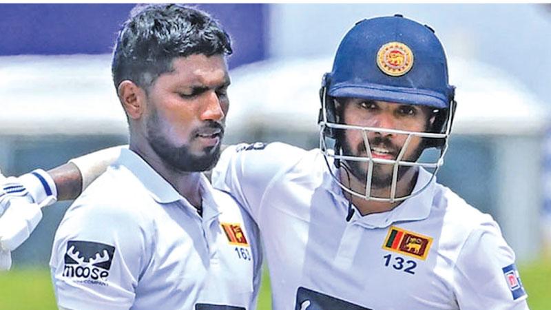 Kusal Mendis (right) hugs his batting partner and Moratuwa town-mate Nishan Madushka. Both Mendis and Madushka scored double hundreds in the second Test against Ireland at the Galle stadium