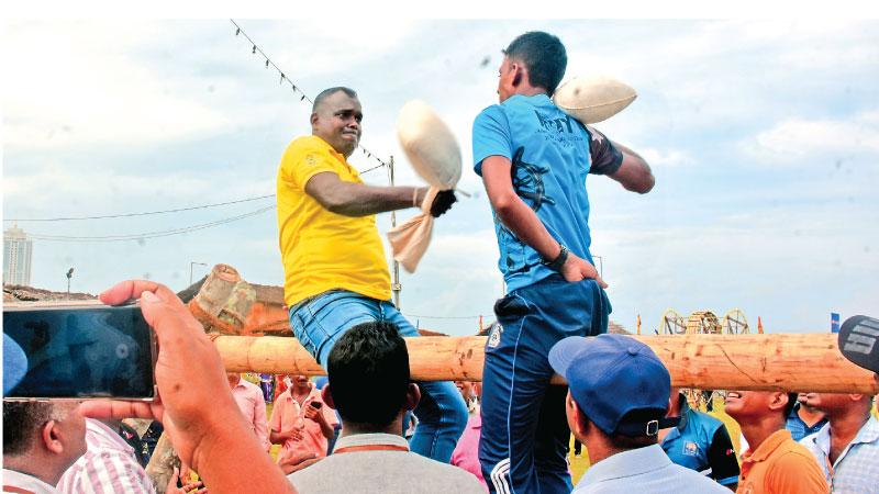 A pillow fight in progress at ‘Wasath Siriya’, the Avurudu festival at the Shangri-La Green at which President Ranil Wickremesinghe was the chief guest.  Pic: Gayan Pushpika