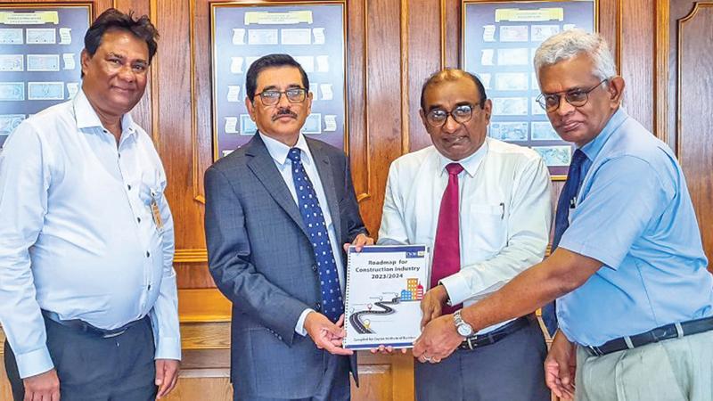 CIOB President Dr. Rohan Karunaratne presents the construction roadmap to CBSL Governor Dr. Nandalal Weerasinghe