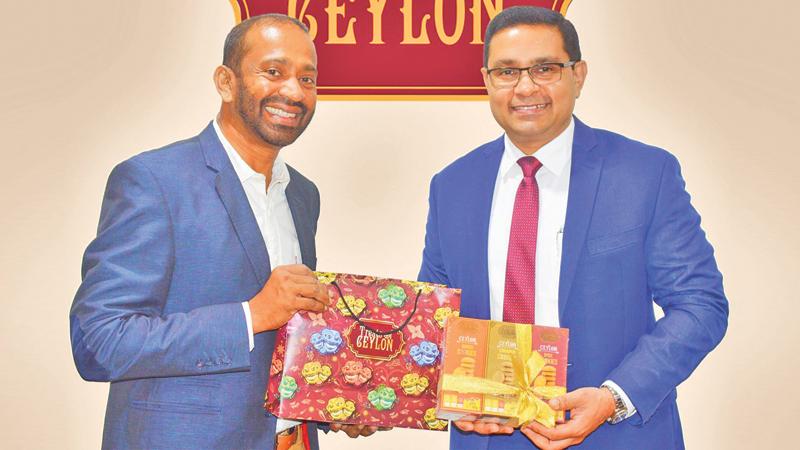 Chairman and MD of Lassana.com, Dr. Lasantha Malavige (left) presents the first batch of ‘Treats of Ceylon’ cookies to MD and CEO of the Commercial Bank, Sanath Manathunge