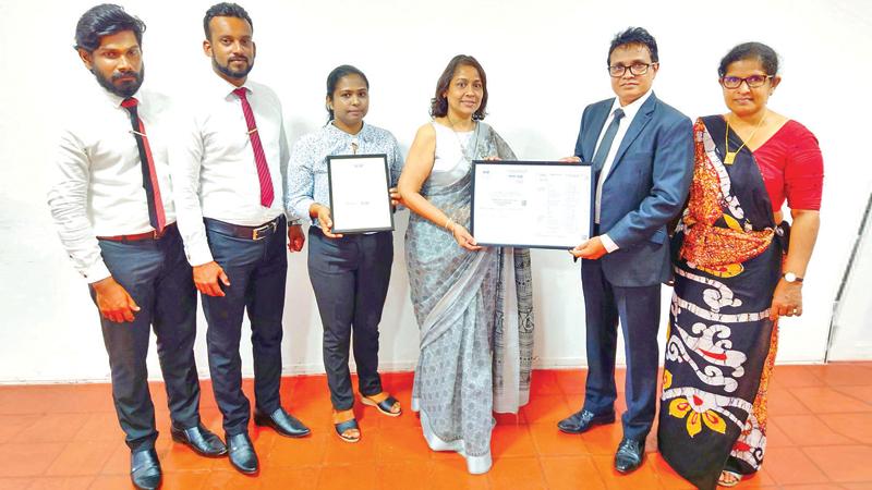Baurs Director of IT Anoja Basnayake and the IT team receive the ISO 17025 accreditation for organic fertiliser from the officials