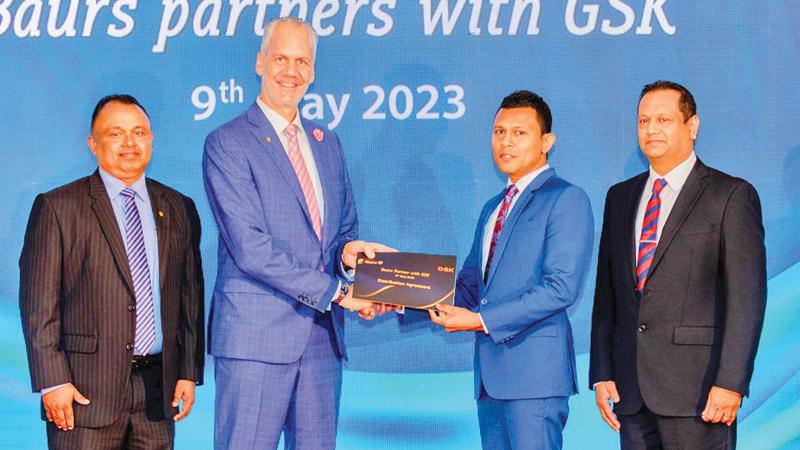 Baurs Managing Director and CEO Rolf Blaser (second from left) exchanges the distribution agreement with GSK Executive Director and CFO and Country Manager, Sri Lanka and the Maldives, Manoj Jayawardena.