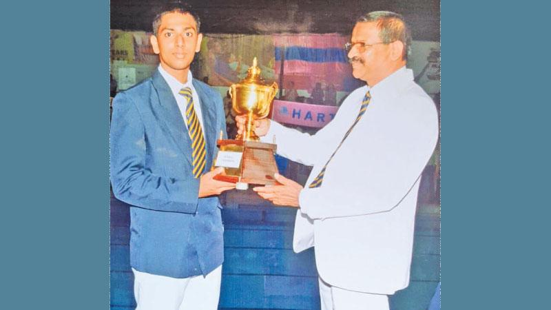 Navija Sehas the vice captain of champions Hartley receiving the Cup from school principal RMM Ratnayake