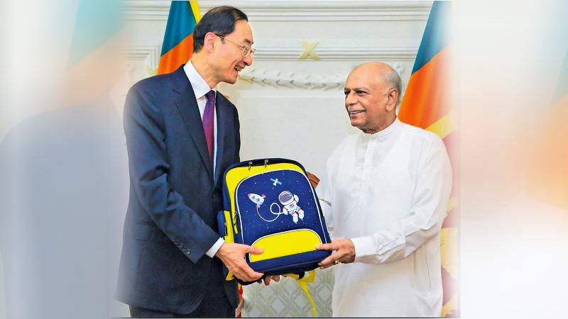 Chinese Vice Minister of Foreign Affairs, Sun Weidong donated 10,000 sets of school bags and  supplies to Prime Minister Dinesh Gunawardena yesterday.