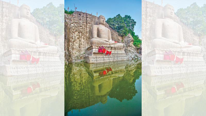 The side view with a pond in front of the Buddha statue