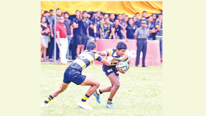St. Peter’s College player Kushan Tharindu breaks away from a tackle against the Royal College defence (Pic by Sudath Nishantha)