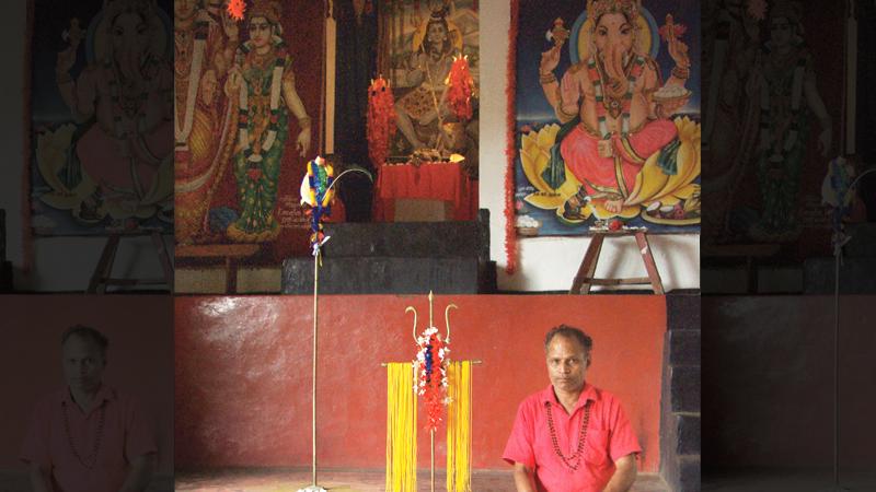 Devala priests clean a massive God Kataragama’s Vel, (lance) to bless devotees on the summit of Vedasitikanda