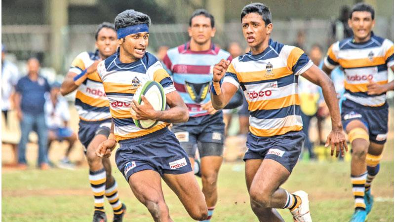 St. Peter’s College full-back Kushan Tharindu out-runs the Dharmaraja College defence in their Dialog trophy inter school league rugby match at the Bogambara Stadium in Kandy yesterday
