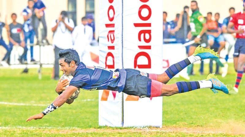 S. Thomas’ College fly-half Malith Perera flies over the line for his second try against Kingswood College at Mount Lavinia yesterday