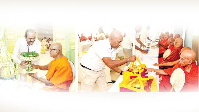 People’s Bank Chairman Sujeewa Rajapakse inviting the Sangha for the chanting of Pirith and Acting CEO Clive Fonseka offering ‘Pirikara’ to the Maha Sangha.