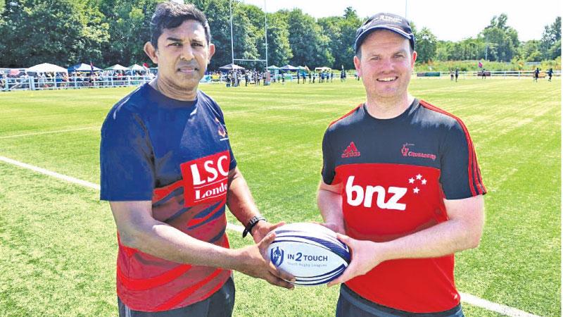 Hayden Burford (right), Regional Manager In2Touch Group presenting a rugby ball to Bandara Wekadapola 