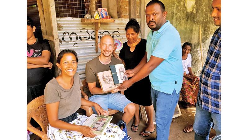 Ranil Wasantha showing his products to tourists