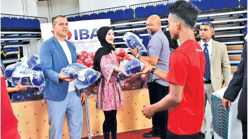 IBA presidet Umar Kremlev, IBA Brand Ambassador Zeina Nassar and Roy Jones Jr presenting gloves to boxers at the Royal MAS Arena