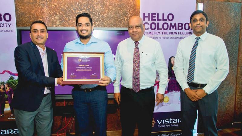 Overseas Manager Sri Lanka for Vistara, Gautam Mehta presents the award to General Manager, Hamoos Travels, Mahesh Wanigasekara. Director/CEO Hayleys Aviation and Projects, Gerard Victoria, and Director North South Lines, Heshan Perera look on.