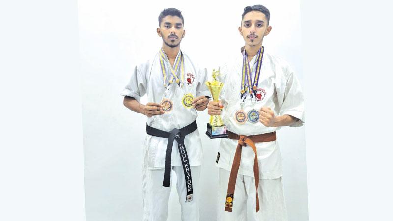 Abdul Kayoom (left) and Raizul Haq pose with their medals