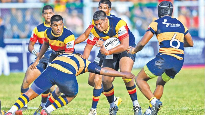 Trinity College’s prop forward Senula Alexander makes a break in their match against Royal College that they won 13-10 at Pallekele yesterday