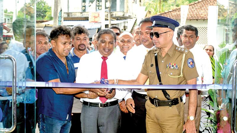 Chairman of LCB Finance Prof. Abeyratne Bandara, President of Walasmulla Trade Association, D. J. Saman Kumara and OIC, Walasmulla Police Station Kingsley Herath open the branch. CEO and Executive Director of LCB Finance, K. G. Leelananda looks on.