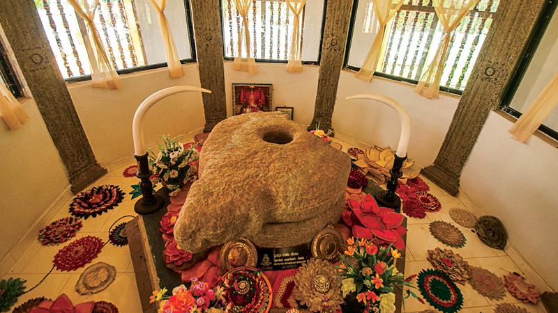 The sacred grinding stone displayed in a specially built venue in the temple for public veneration