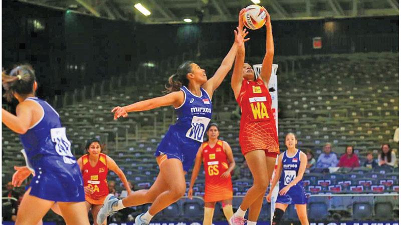 Dulangi Wannithilake (WA) receives a pass in their second game against Singapore played             on Thursday (3)