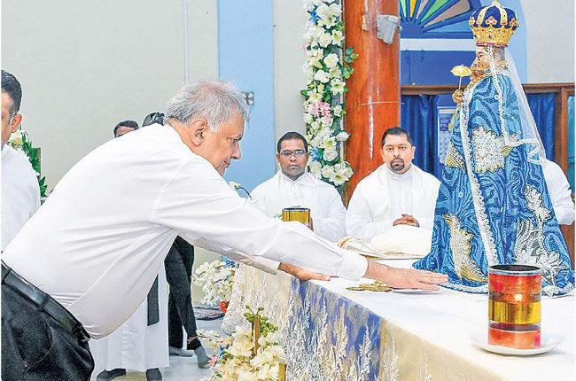 President Ranil Wickremesinghe paying homage to the Our Lady of Madhu Shrine at the annual feast of the Madhu Church in Mannar yesterday.