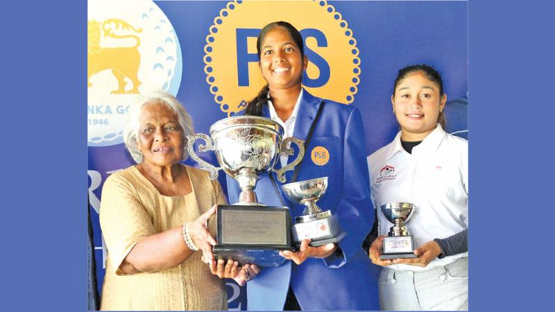 Srima Seneviratne (left) director of P&S Bakers presents the trophy to girls’ winner Kaya Daluwatta with runner-up Sherin Balasuriya at right