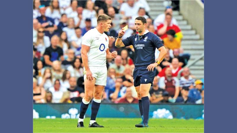 Owen Farrell (left) gets a card