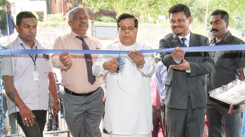 Minister Nimal Siripala De Silva, Secretary to the Ministry of Ports, Shipping, and Aviation, K.D.S. Ruwanchandra and  Director General of the Merchant Shipping Secretariat, Gen. Ajith Wijesinghe open the new secretariat. High-ranking officials look on.