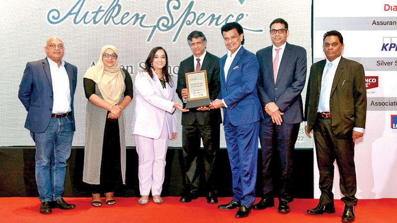  Secretary to the President Saman Ekanayake presents the award to Deputy Chairman and Managing Director of Aitken Spence, Dr. Parakrama Dissanayake and  Executive Director of Aitken Spence Ms. Stasshani Jayawardena