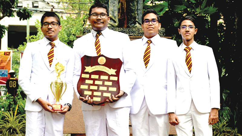 The members of the Ananda College Debating Team with the trophy