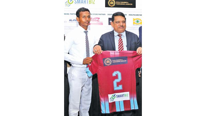 Captain of the Zahira College soccer team Mufazzar Ziard receiving the jersey from the school principal Trizvie Marikar (Pic Ruziak Farook)