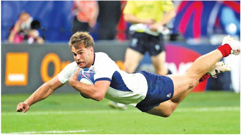 France’s Damian Penaud crosses the line to score against New Zealand in their Rugby World Cup opening match in Paris on Friday night. France won 27-13